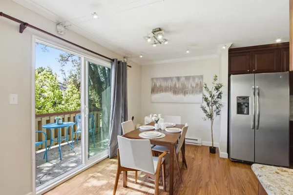 a view of a dining room with furniture large window and wooden floor