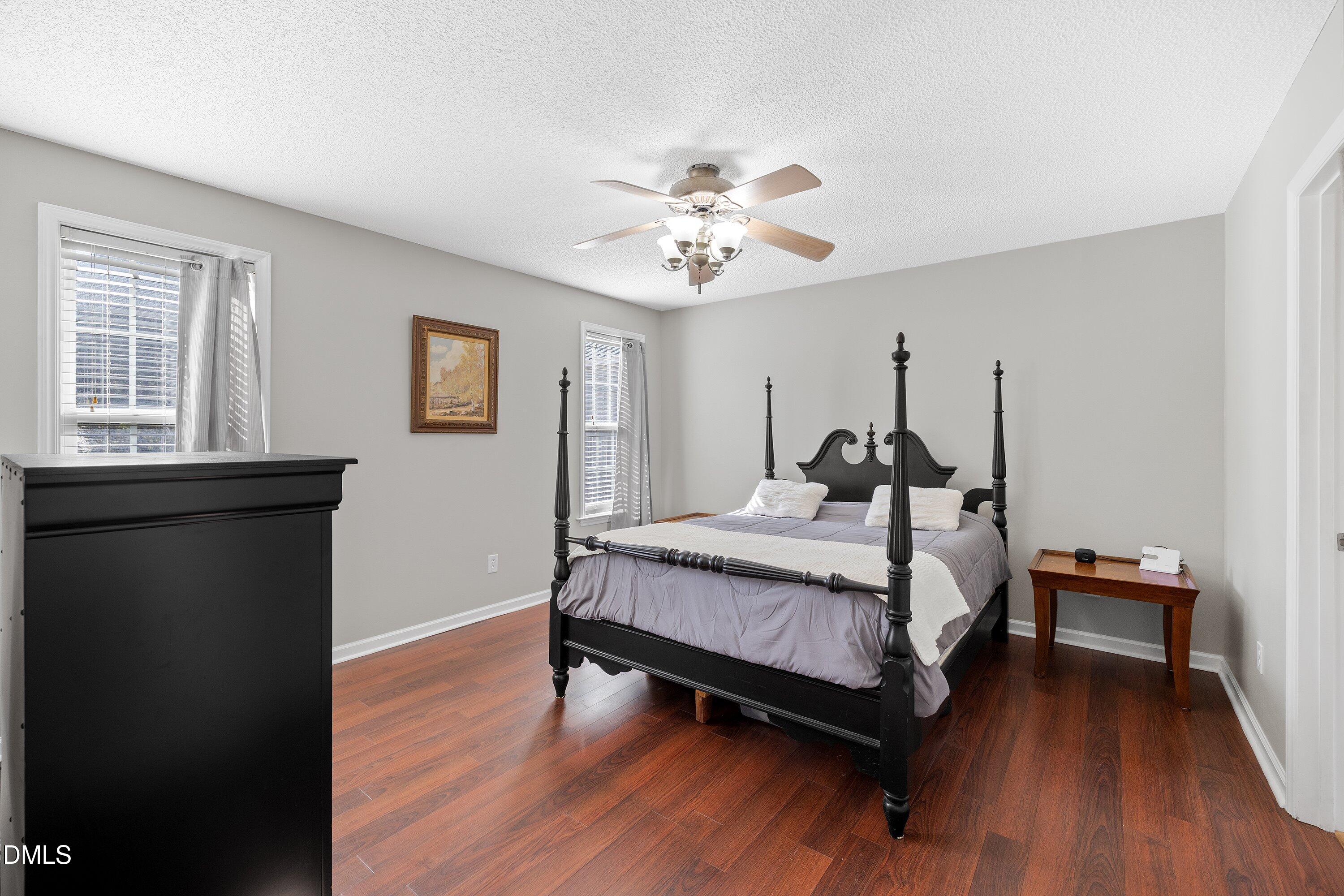 1333 Honeycutt Road Willow Spring, NC 27592 - Photo 14 of 26 a spacious bedroom with a bed and a chandelier