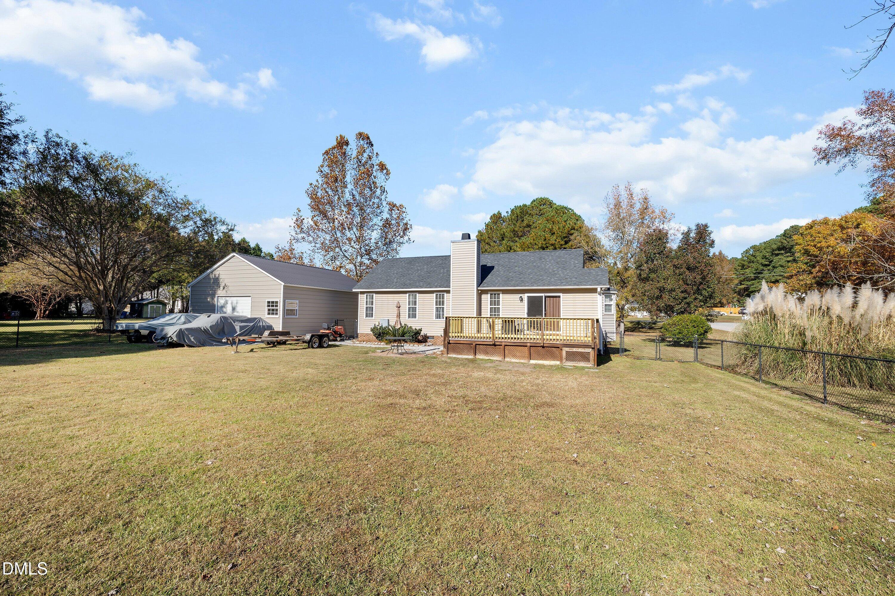 1333 Honeycutt Road Willow Spring, NC 27592 - Photo 23 of 26 a front view of a house with a yard and trees
