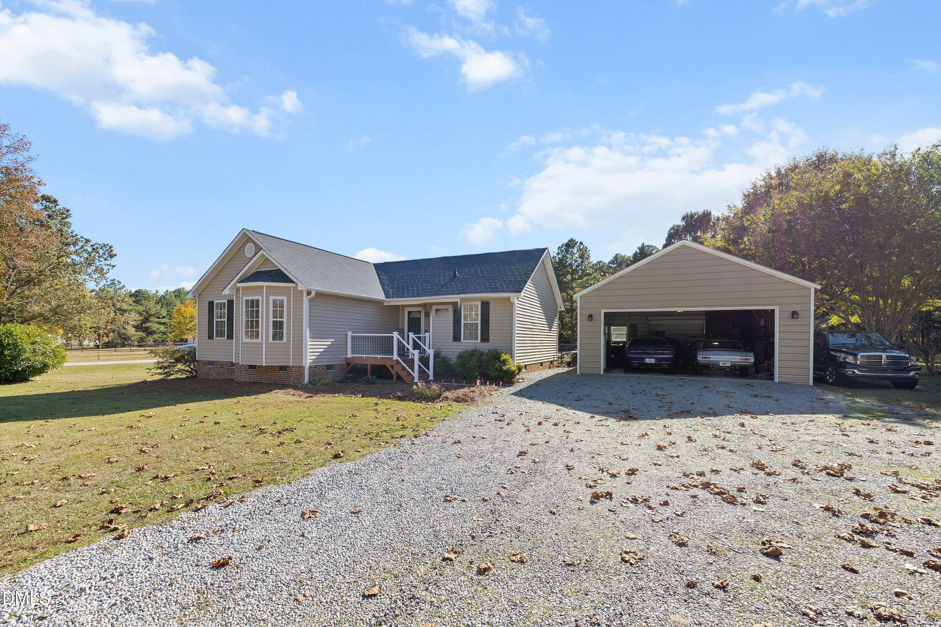 1333 Honeycutt Road Willow Spring, NC 27592 - Photo 3 of 26 a front view of a house with a yard covered with snow in front of house