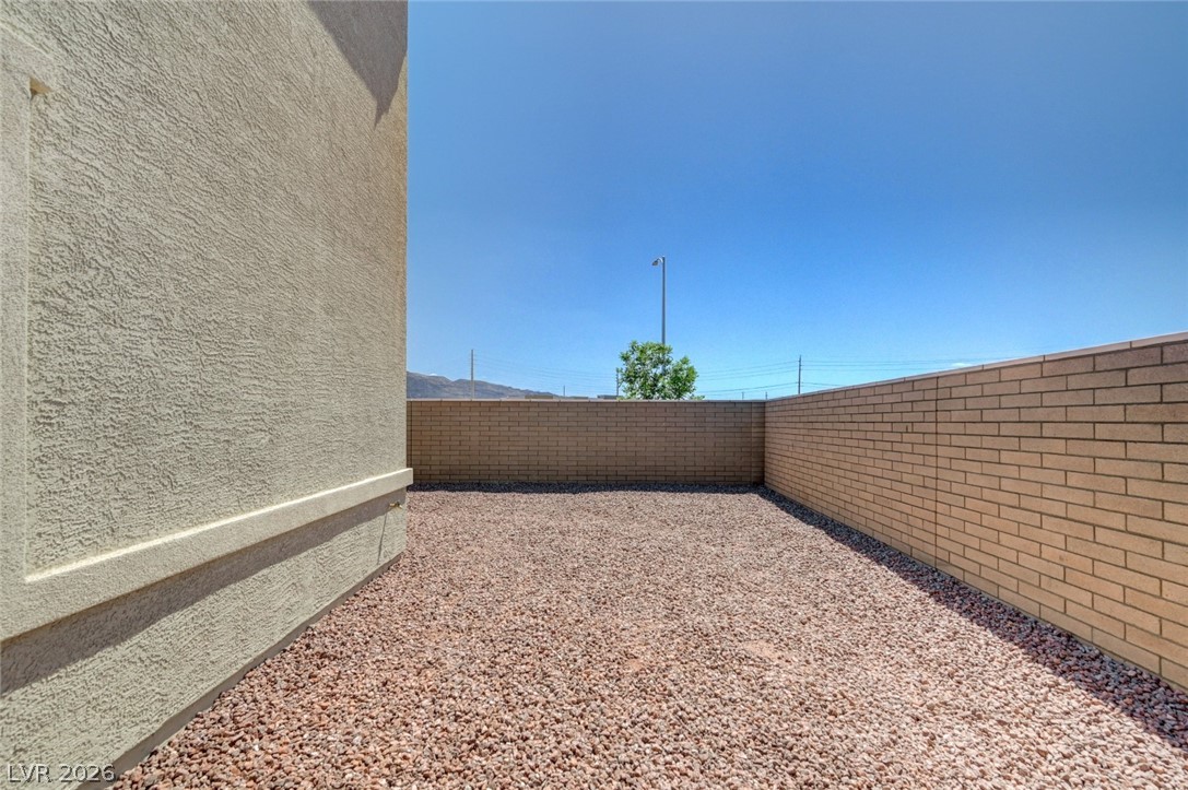 345 Isla Enclave Way Henderson, NV 89011 - Photo 75 of 75 This private yard offers a spacious outdoor area for relaxation and enjoyment.