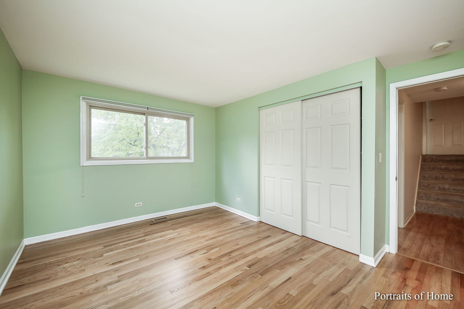 417 South River Road Naperville, IL 60540 - Photo 18 of 27 an empty room with wooden floor closet and windows