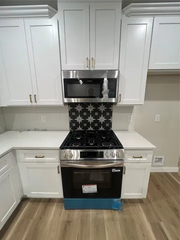 a stove top oven sitting inside of a kitchen