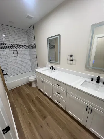 a bathroom with a sink a toilet and mirror