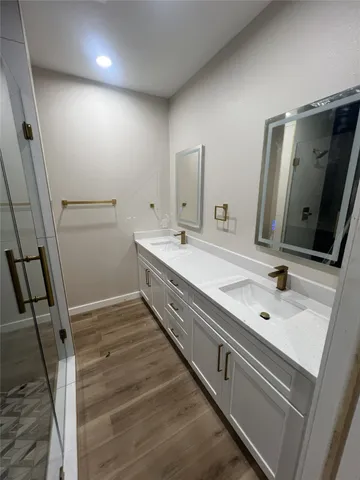 a bathroom with a double vanity sink and mirror