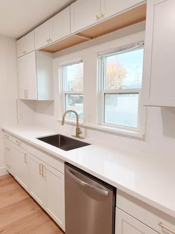 a kitchen with appliances cabinets and a window