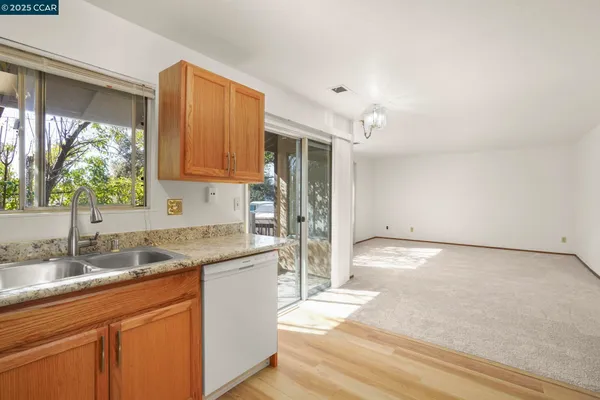 a kitchen with granite countertop a sink and cabinets