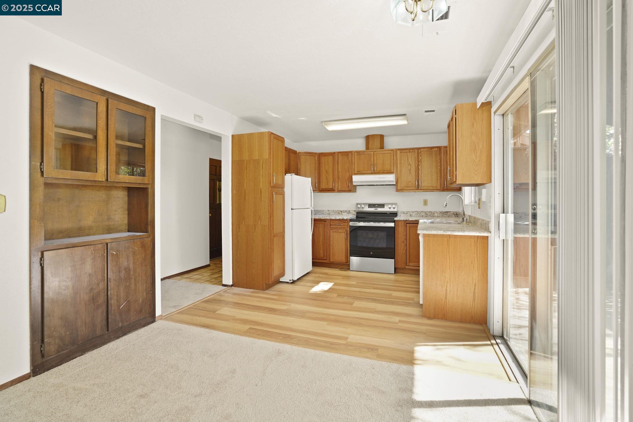1440 Reganti Place, Unit 11 Concord, CA 94518 - Photo 5 of 15 a view of a kitchen with wooden cabinet and stainless steel appliances