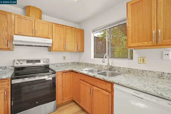 a kitchen with granite countertop a sink and a window