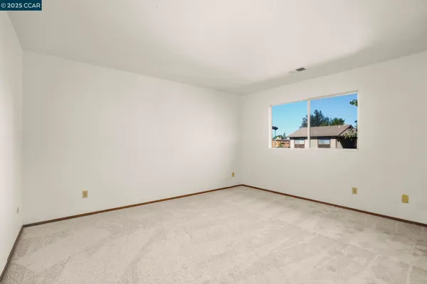 a view of a room with wooden floor and window