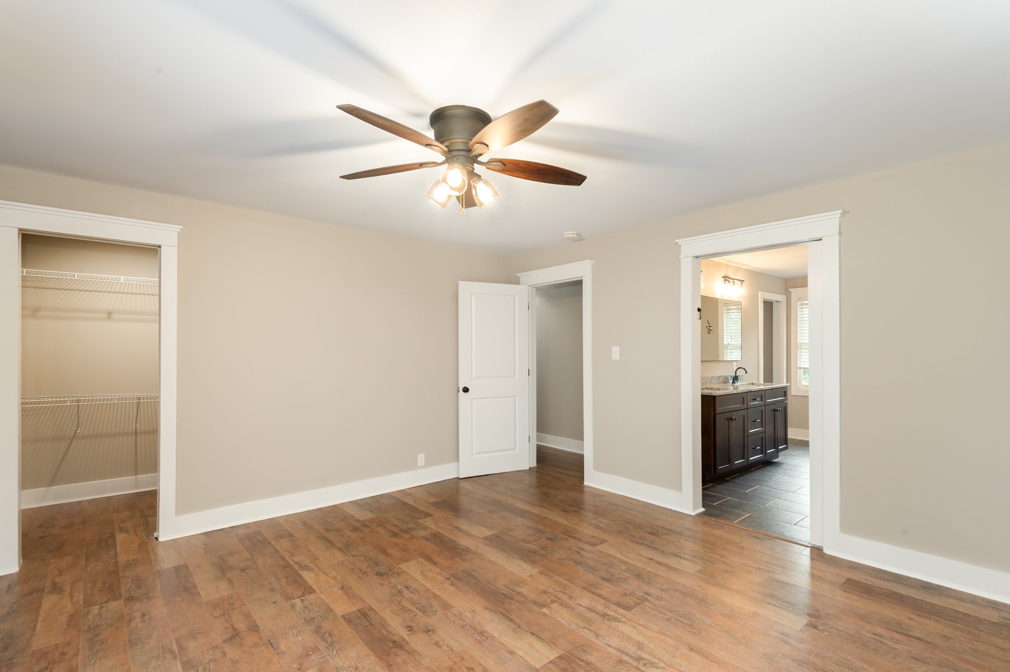 165 Stewart Road Lebanon, TN 37087 - Photo 12 of 26 a view of an empty room with wooden floor and a ceiling fan