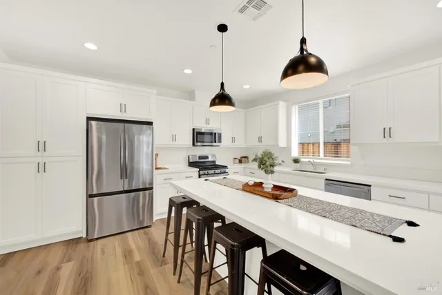 a kitchen with stove cabinets and a wooden floor