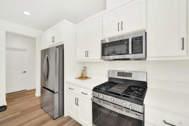 a bedroom with a bed and cabinets