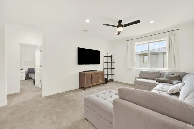 a bedroom with a bed and white cabinets