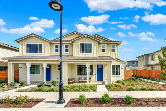 an aerial view of residential building with outdoor space and ocean view