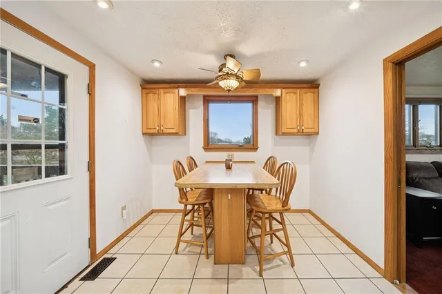 a view of a dining room with furniture and a chandelier