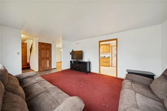 a living room with furniture and large windows