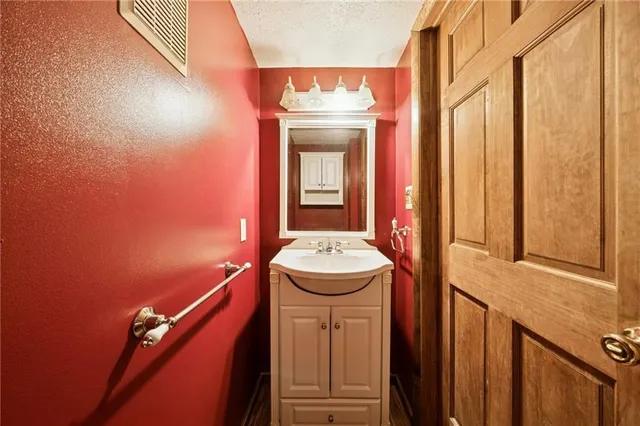 a bathroom with a sink a mirror and a bathtub