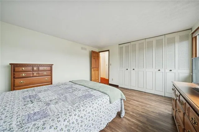 a bedroom with a bed and a dresser