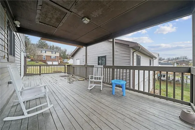 a view of a deck with wooden floor and outdoor seating