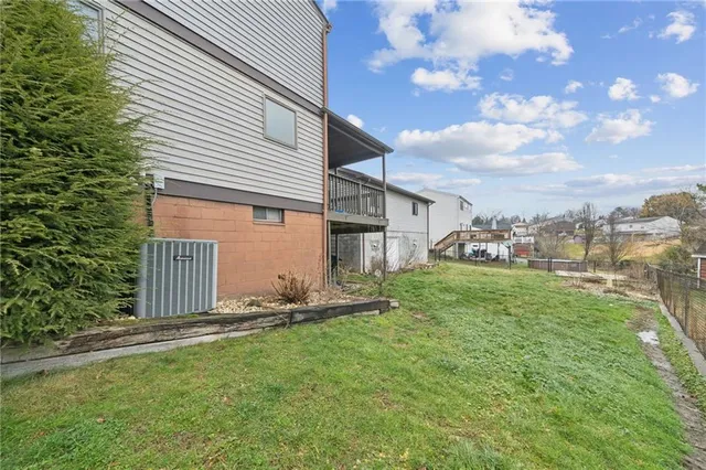 a view of backyard of house with green space