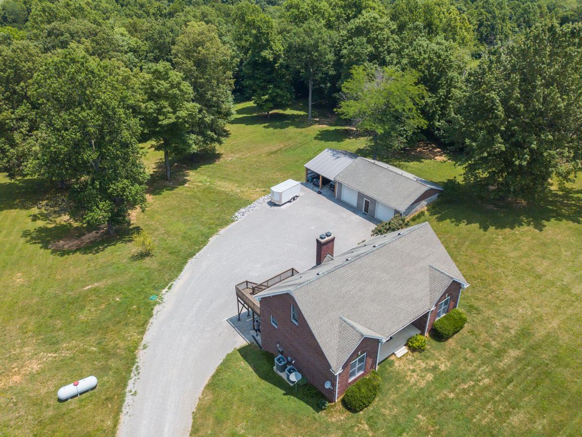 3707 Edd Ross Road Cedar Hill, TN 37032 - Photo 1 of 30 an aerial view of a house with swimming pool and a yard