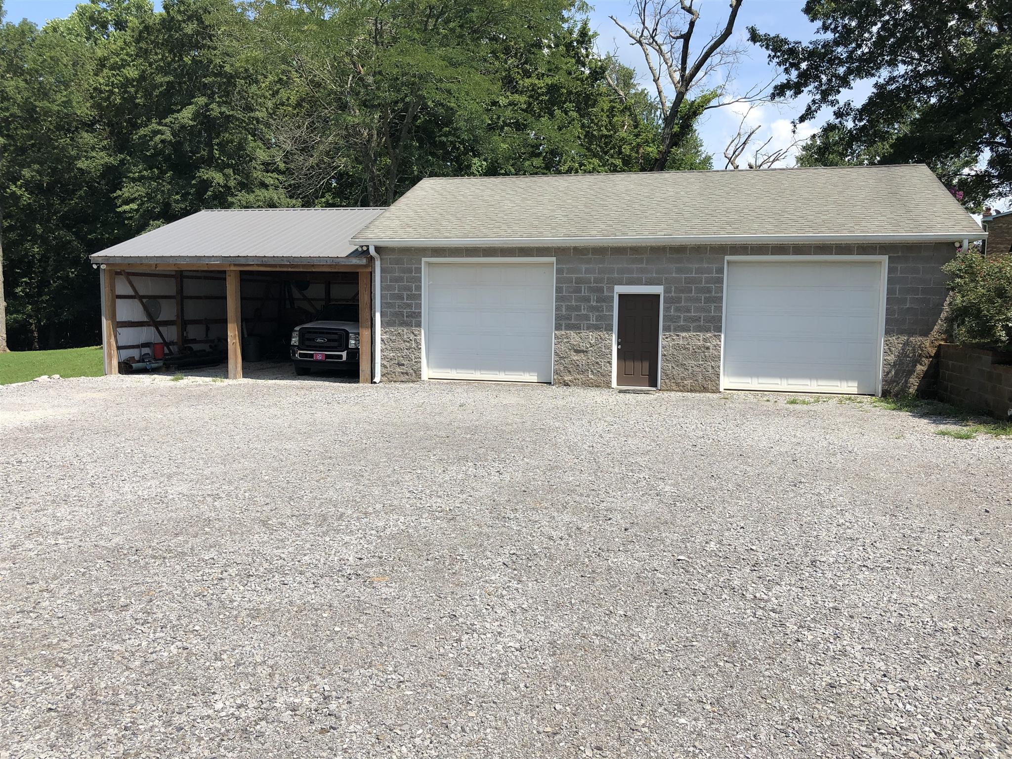 3707 Edd Ross Road Cedar Hill, TN 37032 - Photo 13 of 30 a front view of a house with a yard and garage