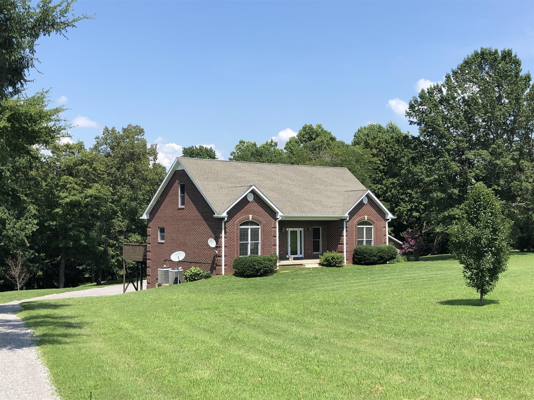 3707 Edd Ross Road Cedar Hill, TN 37032 - Photo 2 of 30 a view of a house with a big yard and large trees