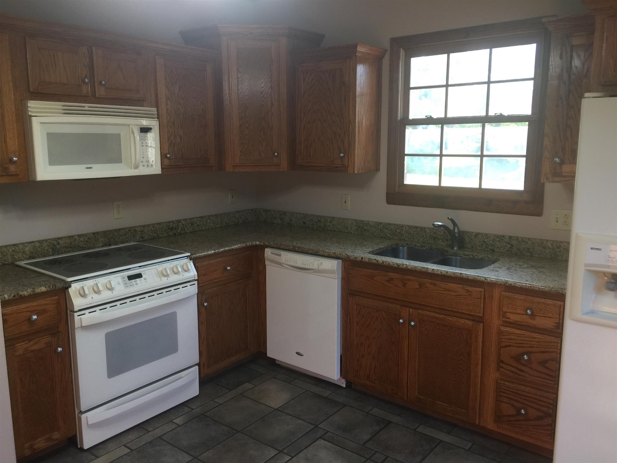 3707 Edd Ross Road Cedar Hill, TN 37032 - Photo 23 of 30 a kitchen with a sink stove and cabinets