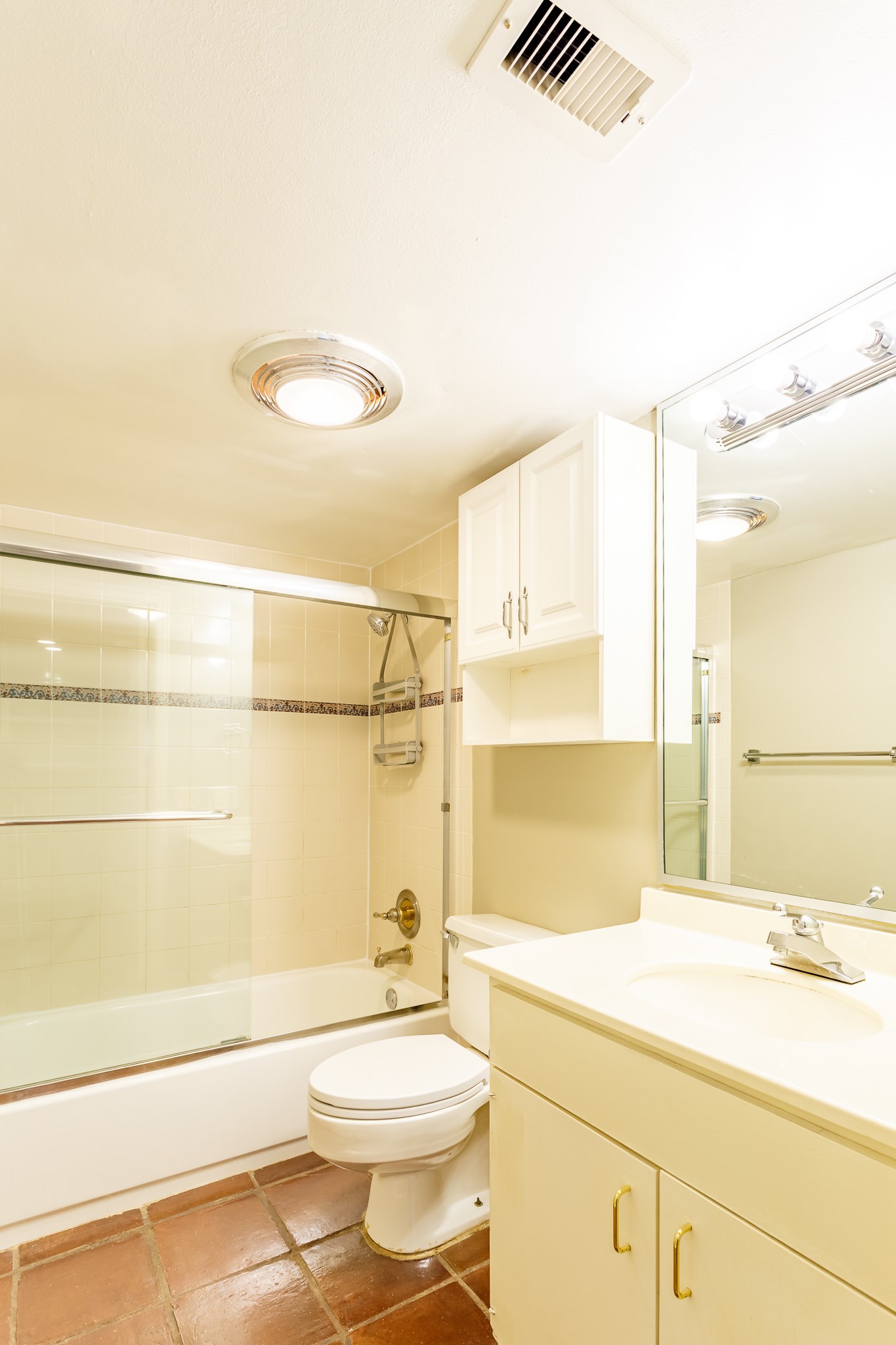 2349 Albans Road, Unit 1 Houston, TX 77005 - Photo 12 of 14 Well-lit bathroom featuring a glass-enclosed bathtub and shower, a vanity with ample storage, and tiled flooring.