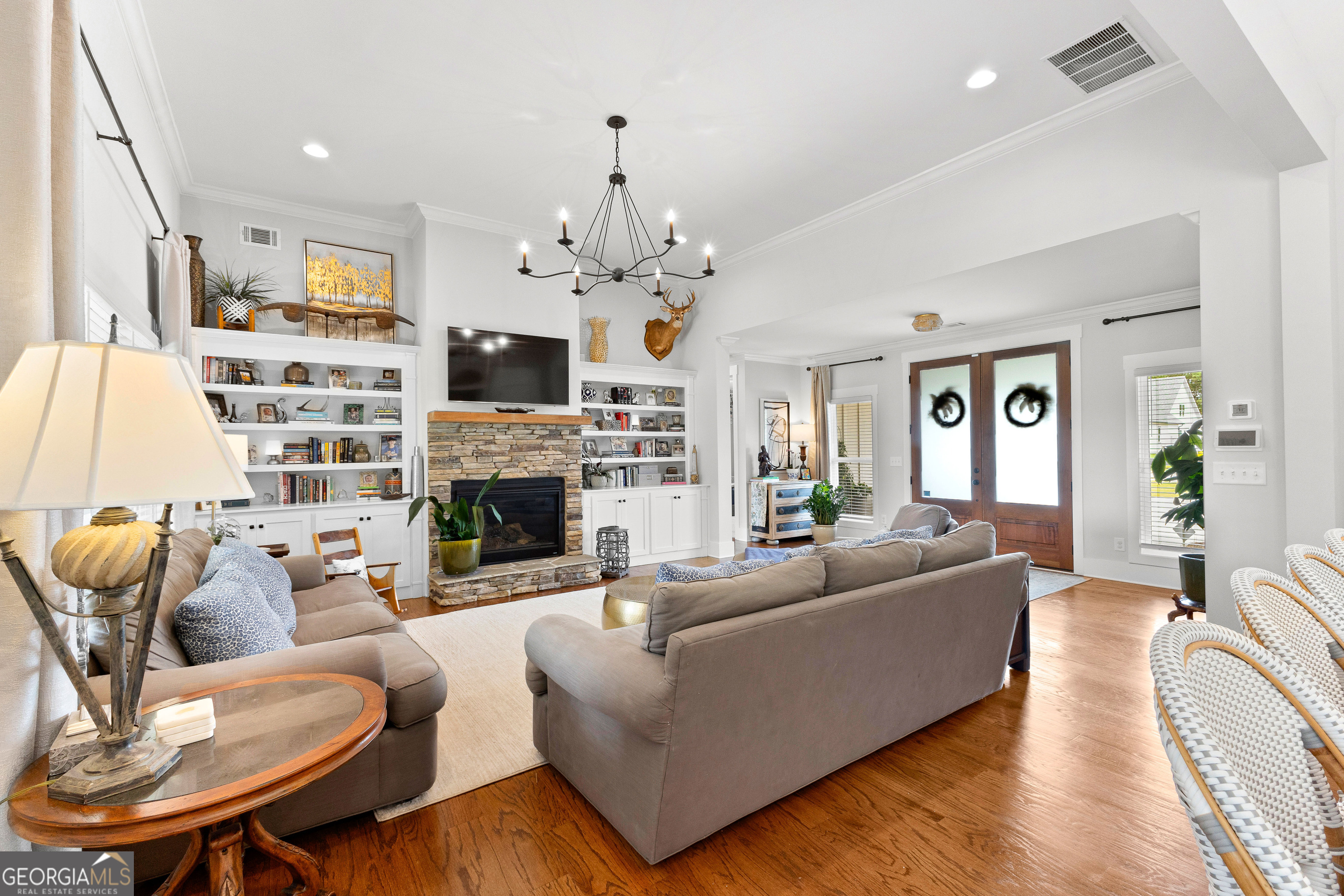 21 Waterview Circle Newnan, GA 30263 - Photo 14 of 75 a living room with furniture a fireplace and a chandelier