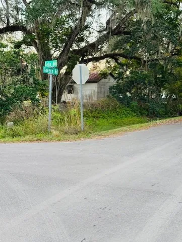 a view of a house with a tree and plants