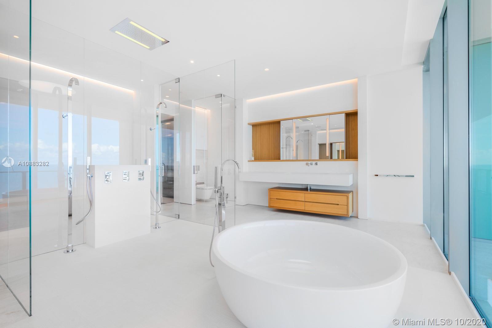 360 Ocean Drive, Unit PH1S Key Biscayne, FL 33149 - Photo 14 of 30 a bathroom with a tub sink and mirror