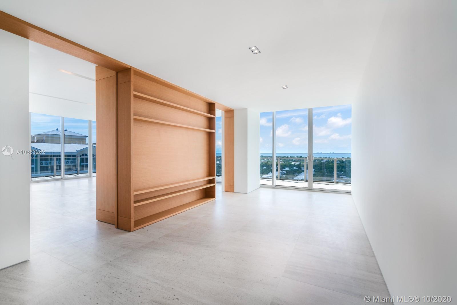 360 Ocean Drive, Unit PH1S Key Biscayne, FL 33149 - Photo 3 of 30 an empty room with sliding door and wooden floor