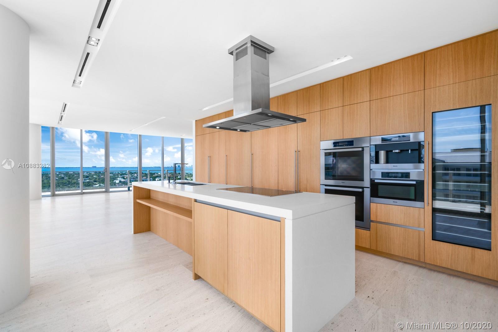 360 Ocean Drive, Unit PH1S Key Biscayne, FL 33149 - Photo 24 of 30 a kitchen with stainless steel appliances kitchen island granite countertop a stove and a refrigerator