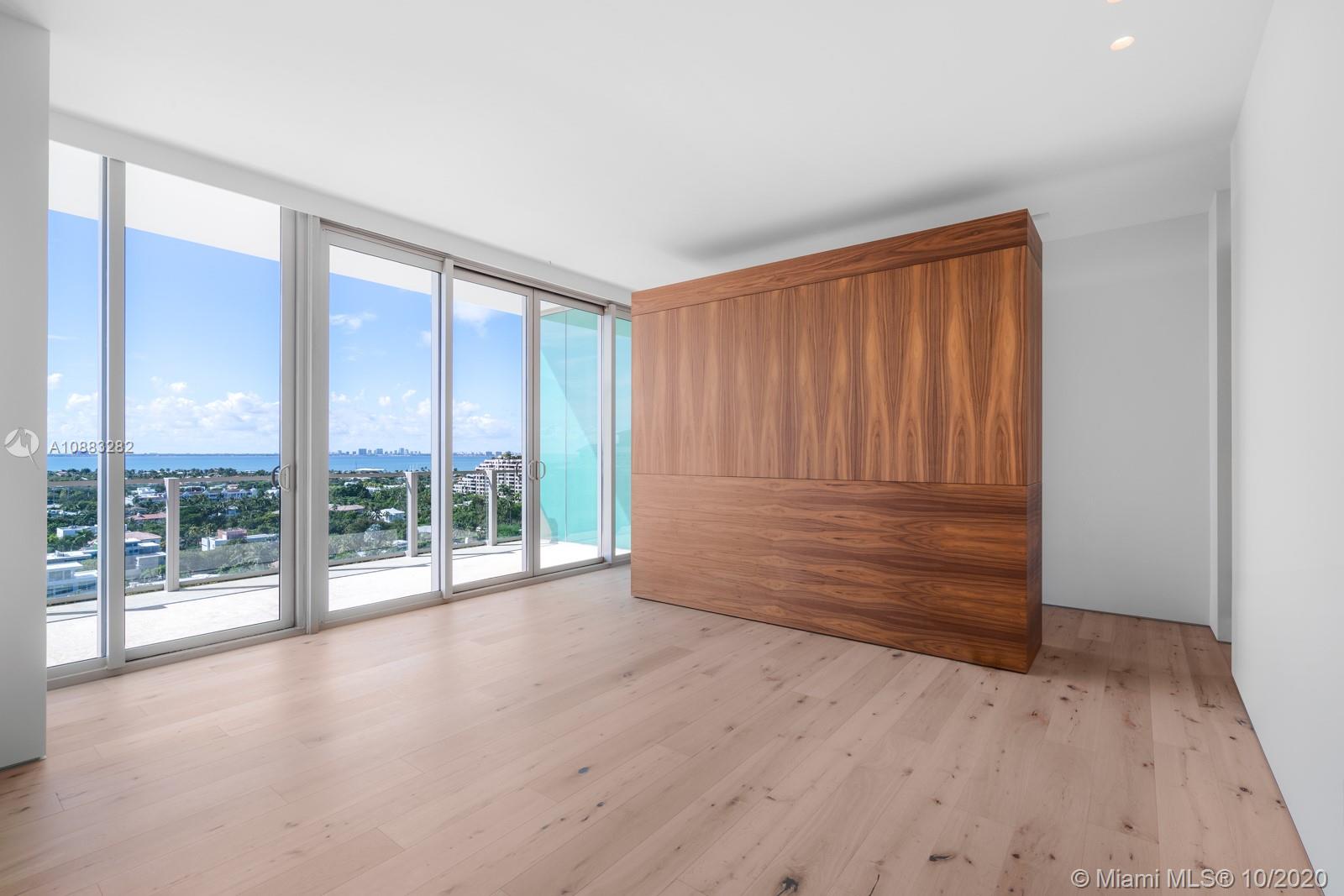 360 Ocean Drive, Unit PH1S Key Biscayne, FL 33149 - Photo 9 of 30 an empty room with wooden floor and windows