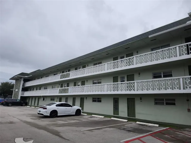 a front view of a building with parking space