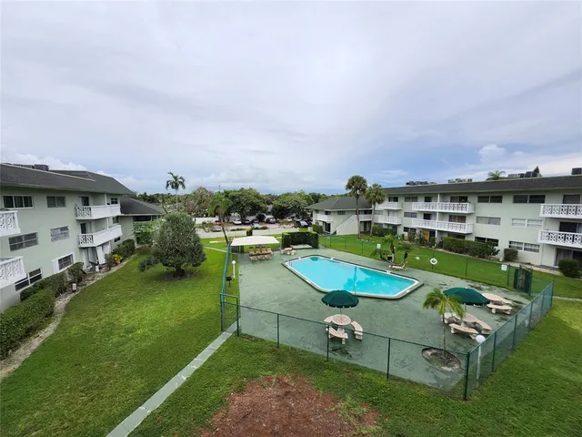 an aerial view of a house with a garden and lake view