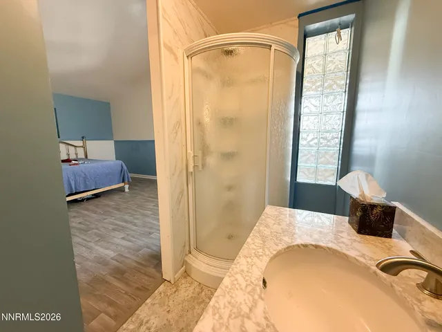 a bathroom with a tub sink and mirror
