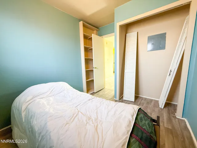 a bed sitting in a bedroom next to a window