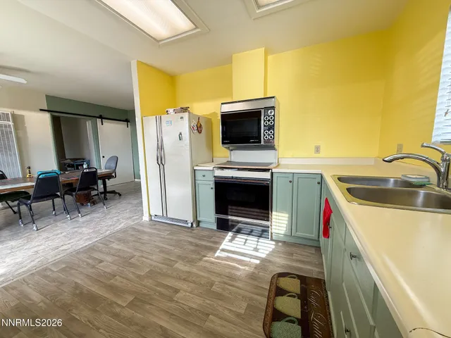 a kitchen with a sink appliances and cabinets