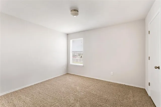 a view of an empty room and a window