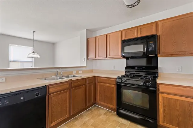 a kitchen with stainless steel appliances a stove sink and cabinets