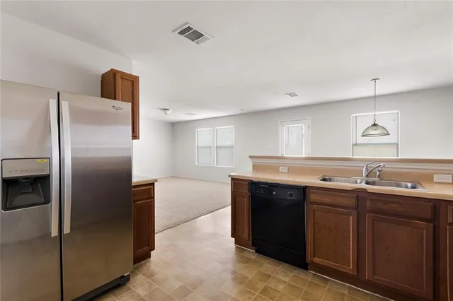 a view of a backyard with wooden fence
