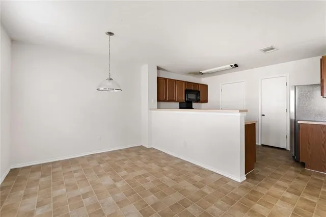 a kitchen with a sink and stainless steel appliances