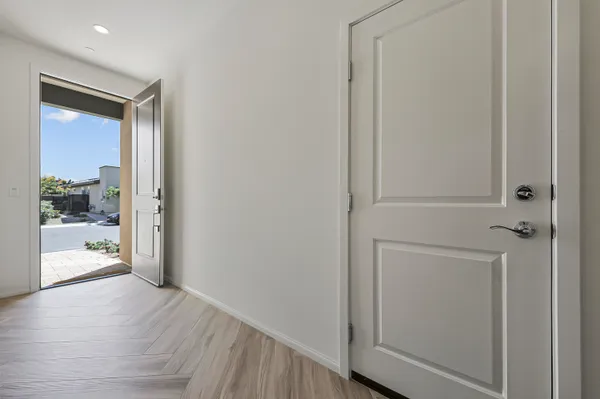 a view of a hallway with wooden floor