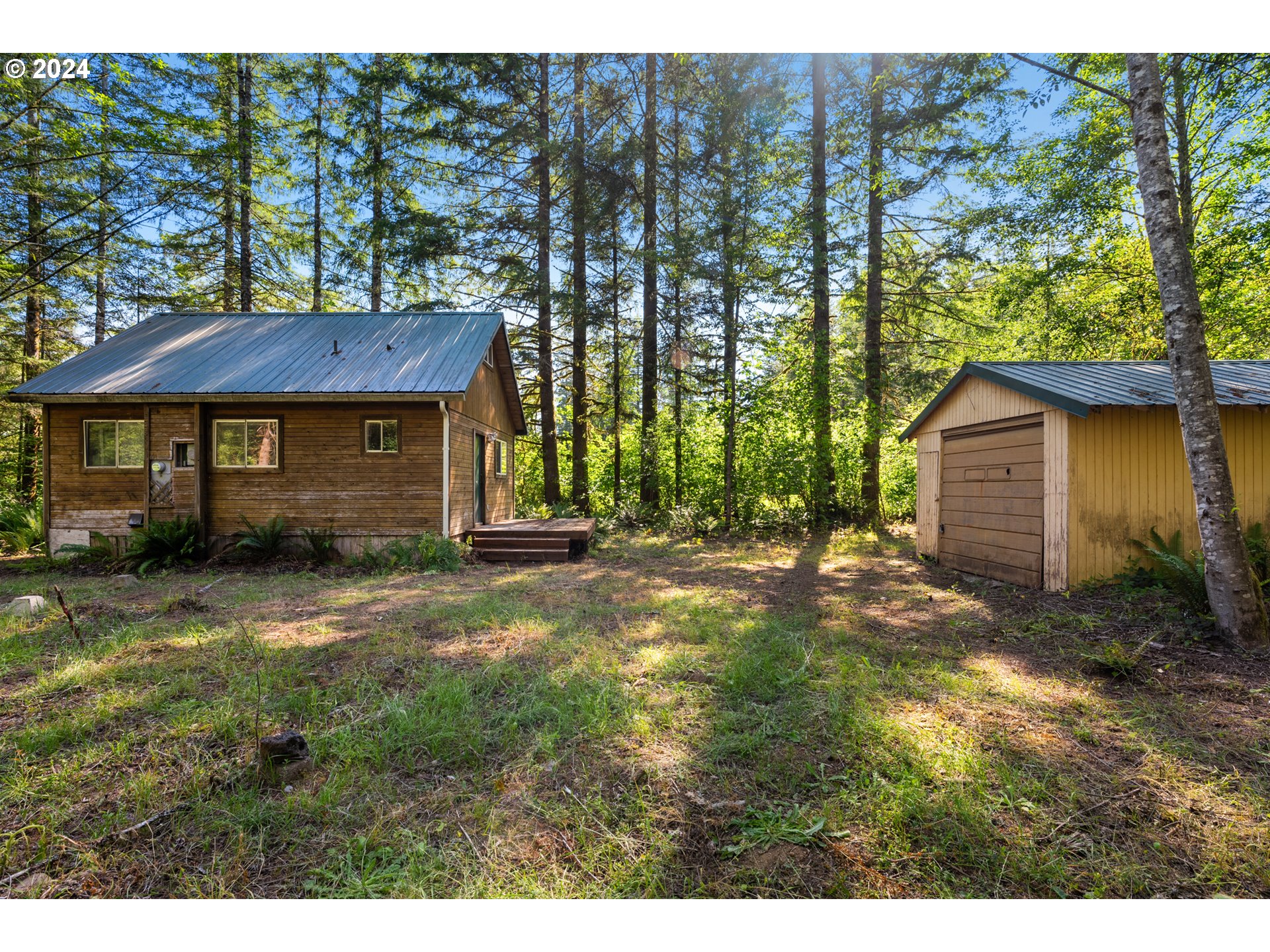 14644 Lewis River Road Ariel, WA 98603 - Photo 5 of 28 a front view of a house with a garden