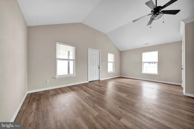 a kitchen with granite countertop a sink a stove and cabinets