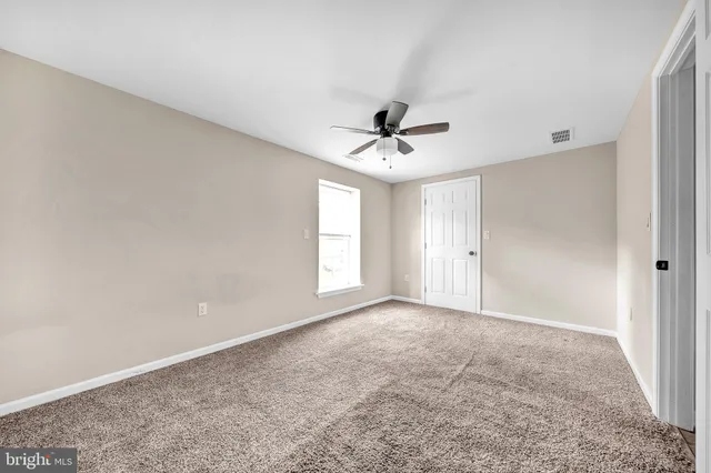 a view of a livingroom with a ceiling fan and window
