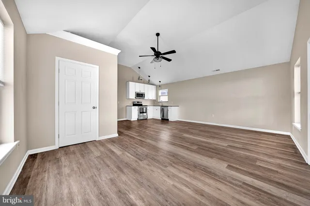 a view of kitchen with sink microwave and wooden floor